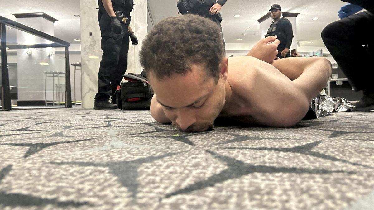 FILE PHOTO: Law enforcement personnel detain Cole Tomas Allen, a suspect in the shooting incident at the White House Correspondents' Association dinner, in Washington, D.C., U.S. April 25, 2026. DONALD J TRUMP via Truth Social/Handout via REUTERS/File Photo