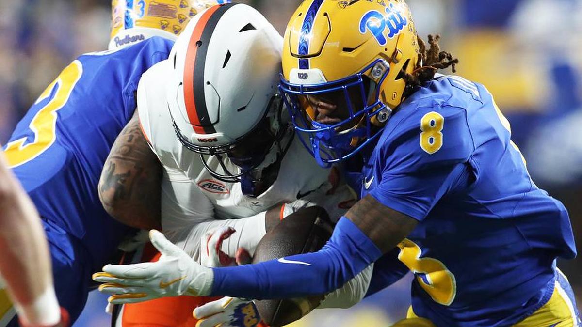  Nov 9, 2024; Pittsburgh, Pennsylvania, USA; Pittsburgh Panthers defensive back Tamon Lynum (8) intercepts a pass intended for Virginia Cavaliers wide receiver Malachi Fields (middle) during the first quarter at Acrisure Stadium. Mandatory Credit: Charles LeClaire-Imagn Images | Charles LeClaire-Imagn Images 