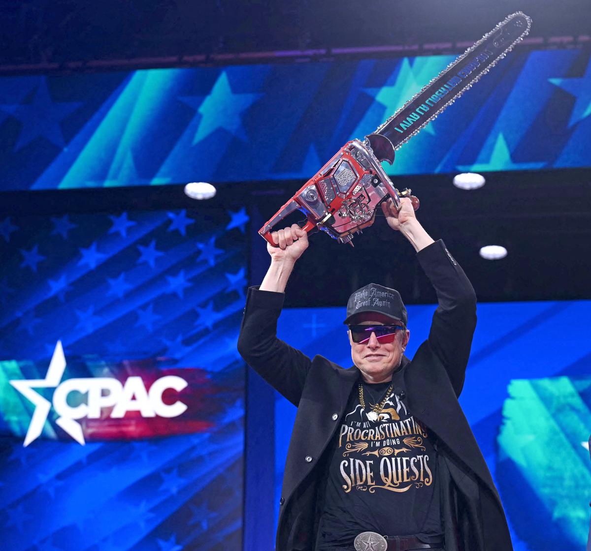Elon Musk holds a chainsaw reading “Long live freedom, damn it” during the annual Conservative Political Action Conference in Maryland last month.