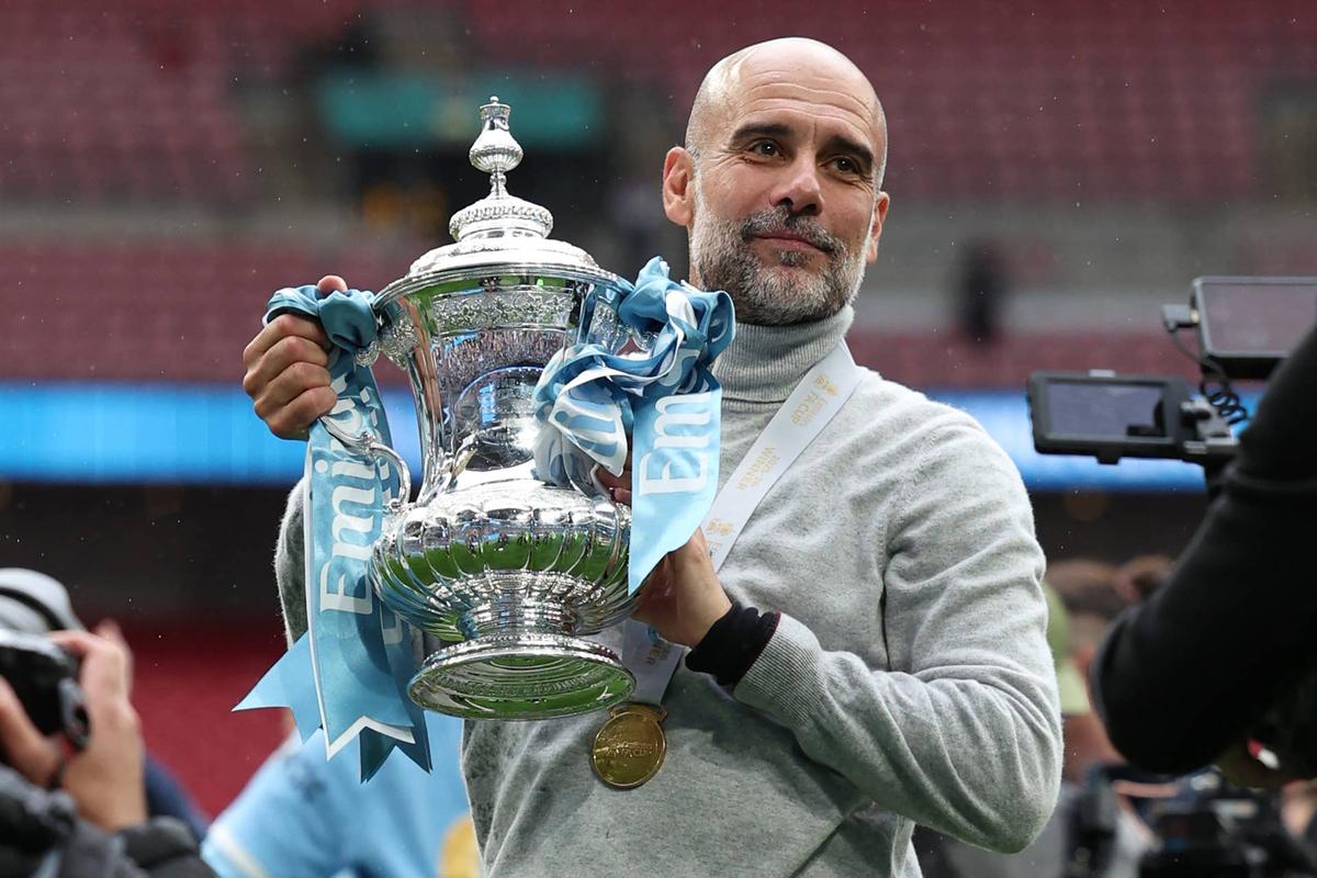  Manchester City's Spanish manager Pep Guardiola poses with the trophy on the pitch after the English FA Cup final football match between Chelsea and Manchester City at Wembley stadium in London, on May 16, 2026. Manchester City won the game 1-0. The third FA Cup success of Guardiola's reign ended City's run of two successive defeats in the final. (Photo by Adrian Dennis / AFP via Getty Images) / NOT FOR MARKETING OR ADVERTISING USE / RESTRICTED TO EDITORIAL USE