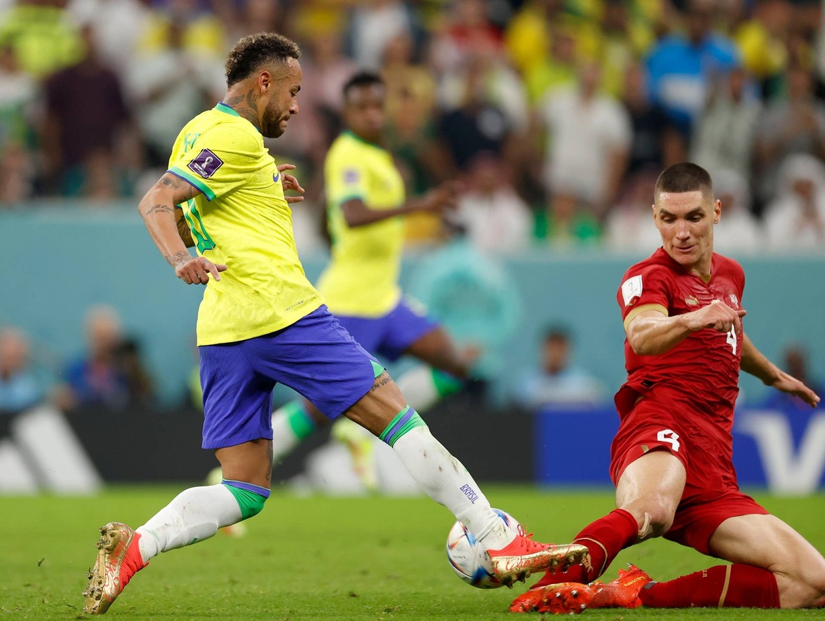  Brazil forward Neymar (10) kicks the ball past Serbia defender Nikola Milenkovic (4). 