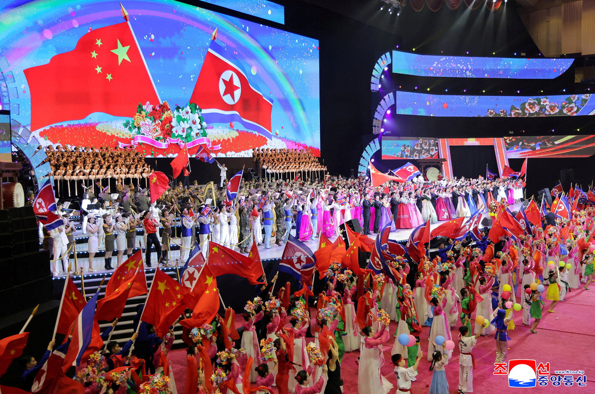 The flags of North Korea and China are waved on stage during a performance at the Pyongyang Indoor Stadium, during Chinese President Xi Jinping's state visit, in Pyongyang, North Korea, June 8, 2026, in this picture released by North Korea's official Korean Central News Agency.   KCNA via REUTERS