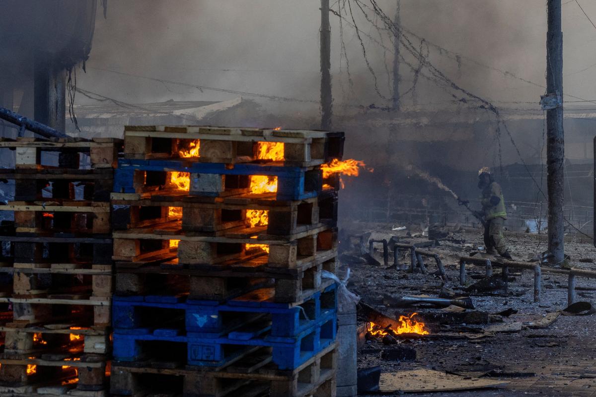 A firefighter works at the site of a fire after overnight Russian missile and drone attacks, amid Russia's attack on Ukraine, in Kyiv, Ukraine, May 24, 2026. REUTERS/Thomas Peter
