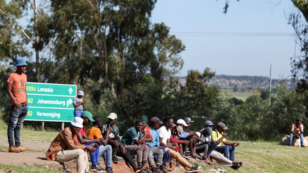 Job seekers wait beside a road for casual work offered by passing motorists in Eikenhof, south of Johannesburg, South Africa, February 26, 2025. REUTERS/Siphiwe Sibeko