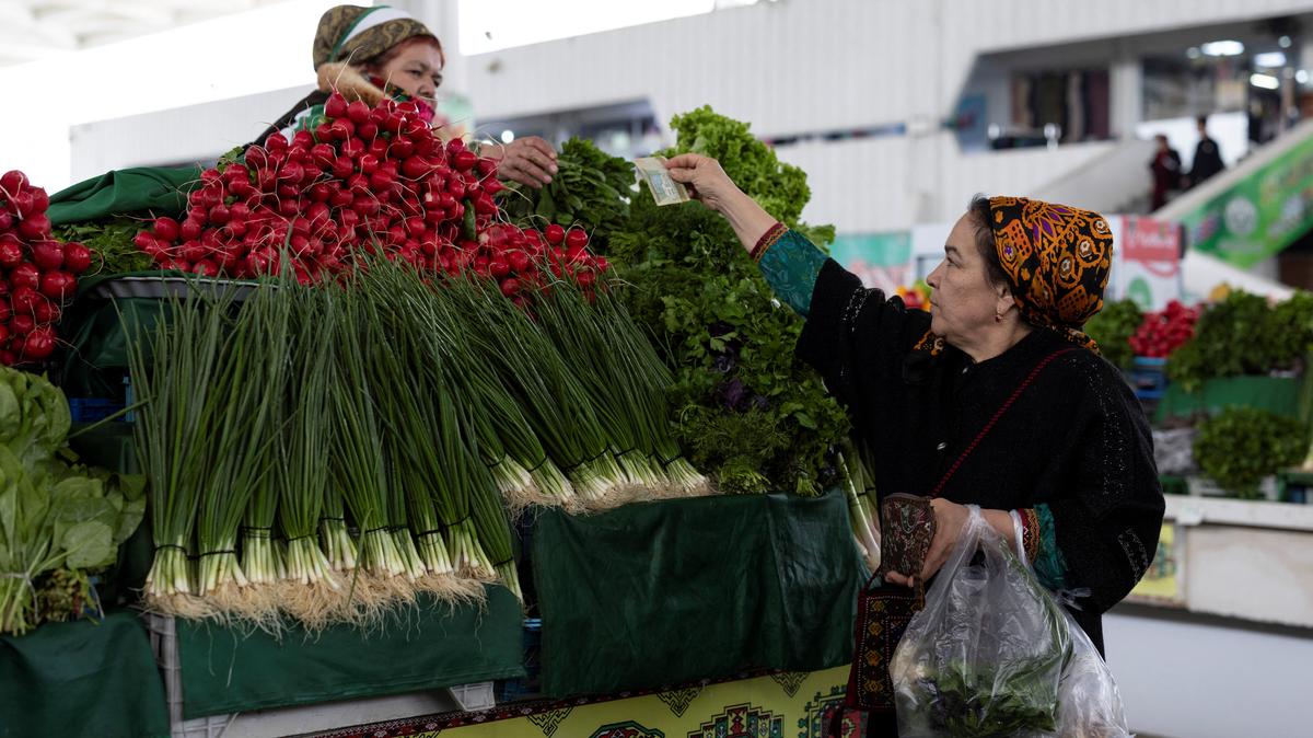 A woman buys vegetables at an open market in Ashgabat, Turkmenistan, March 17, 2026. REUTERS/Umit Bektas