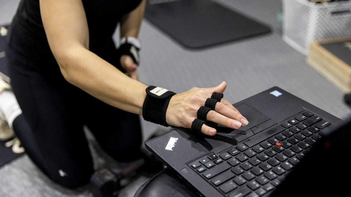 Sarah Dunay, 45, exercises on May 17 at home in Perry, Ohio. Dunay exercises five days a week using a menopause workout program. "I can't say enough about how confident I feel in my body," she said.