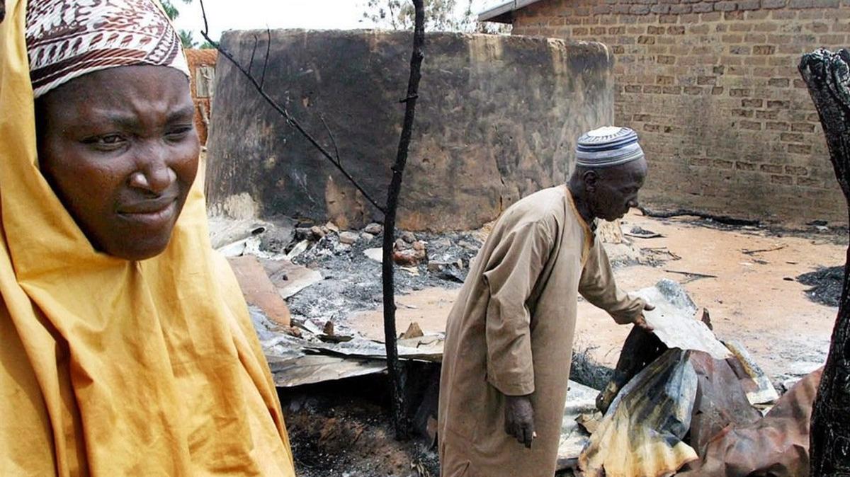 A Nigerian Muslim woman and her husband assess the damage to their home in the town of Yelwa, Friday on May 7, 2004. On May 2, Nigerian Christian militants attacked the Muslim town of Yelwa with firearms and machetes in reprisal for an attack in February 2004. File Photo by Stringer/EPA