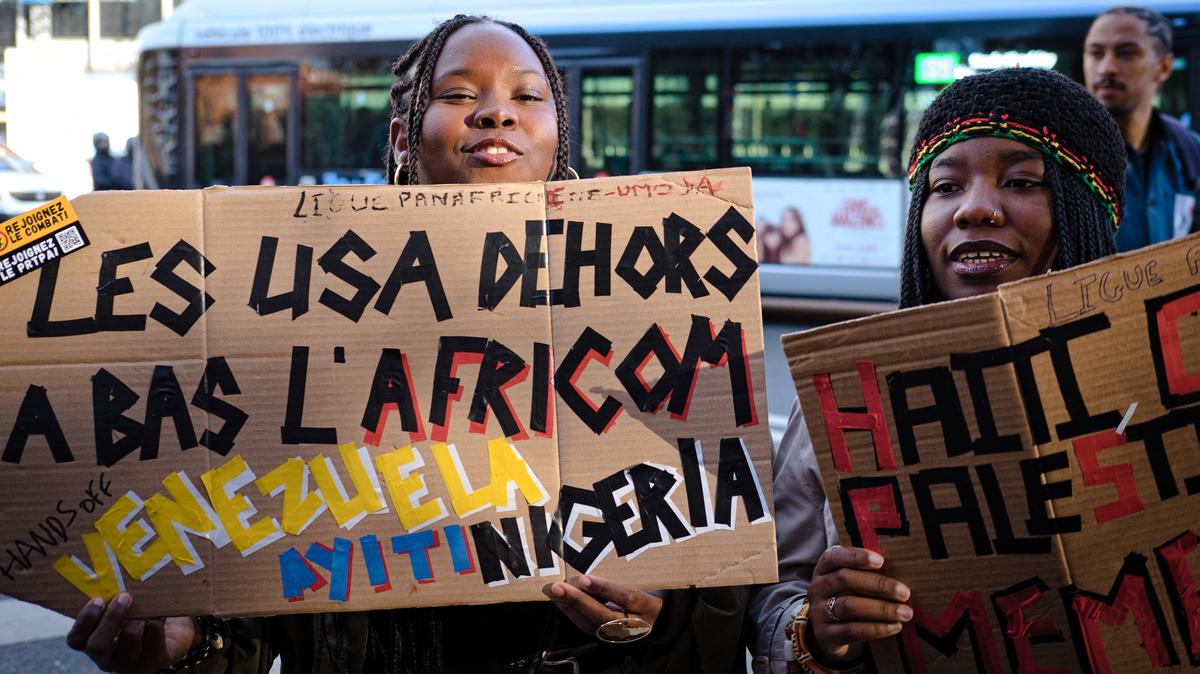A protester holds a sign reading "USA out, down with Africom" at a march for peace, against imperialist wars and the war economy, in Paris on Nov. 5, 2025. (Djoudi Hamani/Hans Lucas/AFP/Getty Images)