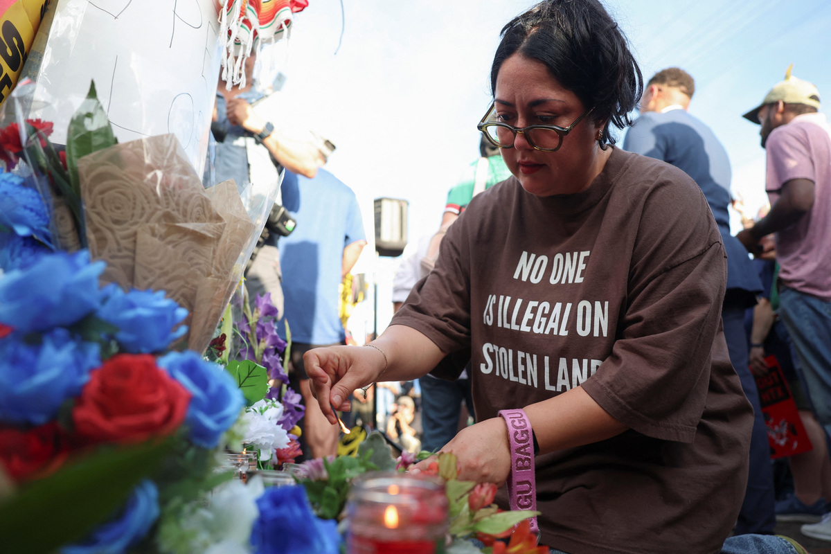A woman lights a candle during a vigil after the fatal shooting of Mexican motorist Lorenzo Salgado Araujo by an ICE agent in Houston, Texas, U.S., July 8, 2026. REUTERS/Antranik Tavitian