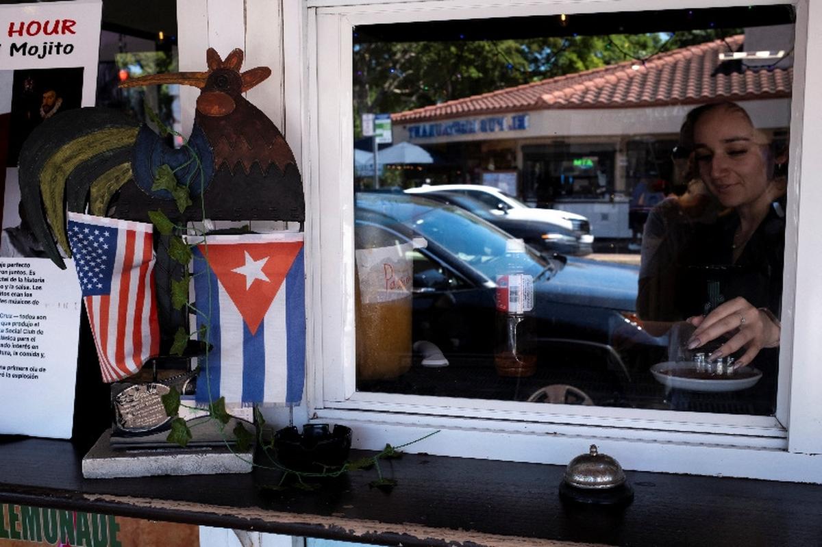 U.S. and Cuban flags are displayed outside a bar in the Little Havana neighborhood in Miami, Florida, U.S., May 15, 2026. REUTERS/Marco Bello