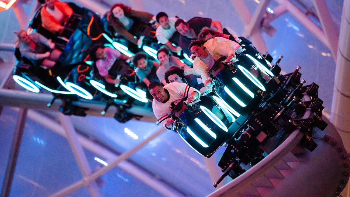 Magic Kingdom visitors hang on during the Tron Lightcycle / Run coaster during a Disney After Hours event at Magic Kingdom theme park. (Steven Diaz/Walt Disney Co./TNS)