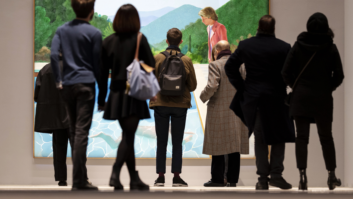 People view David Hockney's "Portrait of an Artist (Pool with Two Figures)", the day before it was auctioned for $90 million, at Christie's in New York, Nov. 14, 2018. Hockney, whose colorful figurative paintings were both conservative and iconoclastic, defying the dominant abstract schools of the mid-20th century, died at home in London on June 11, 2026. He was 88. (Karsten Moran/The New York Times)