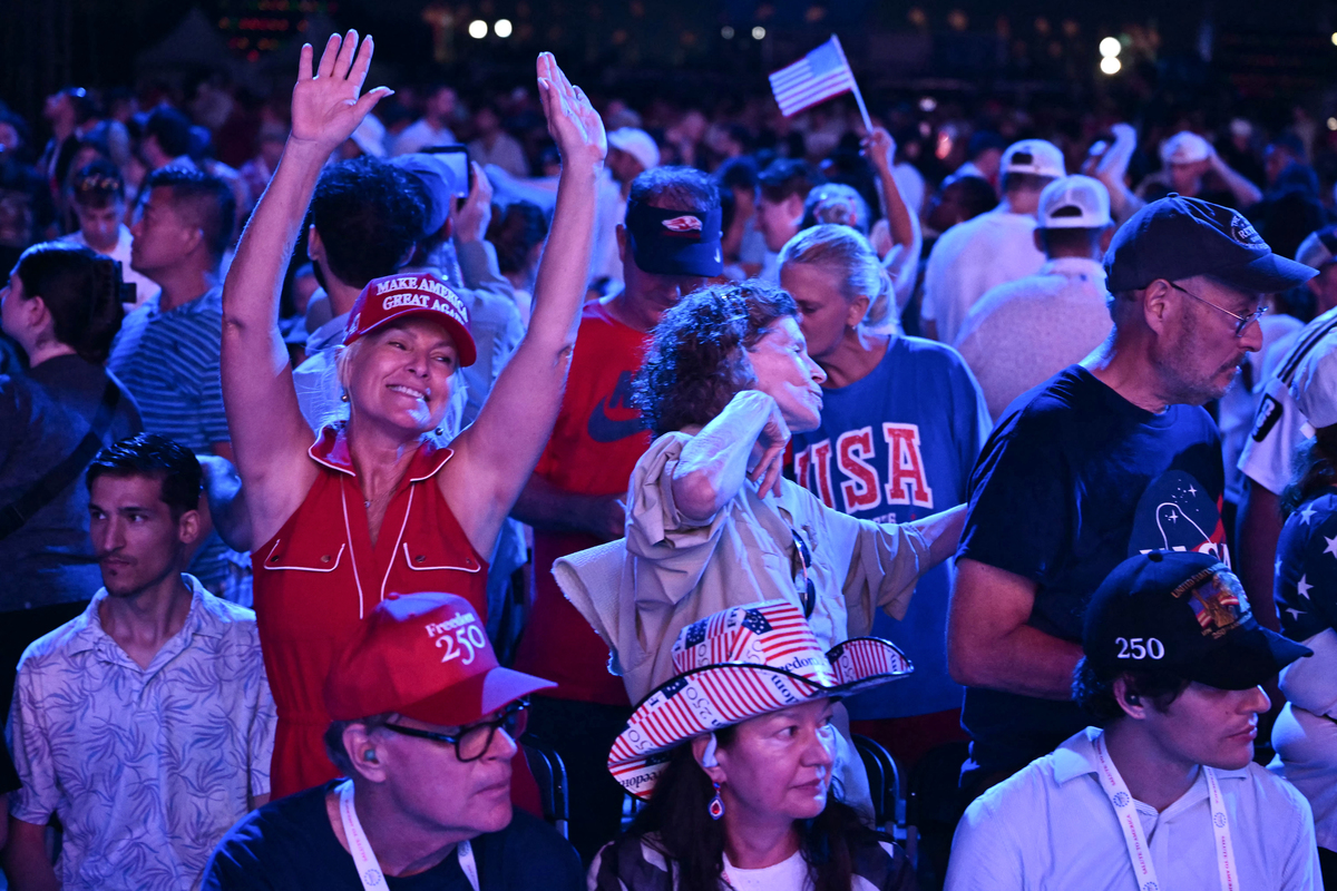  People wait for US President Donald Trump to take the stage to speak during the “Salute to America” Independence Day celebration on the National Mall in Washington, DC, on July 4, 2026. 