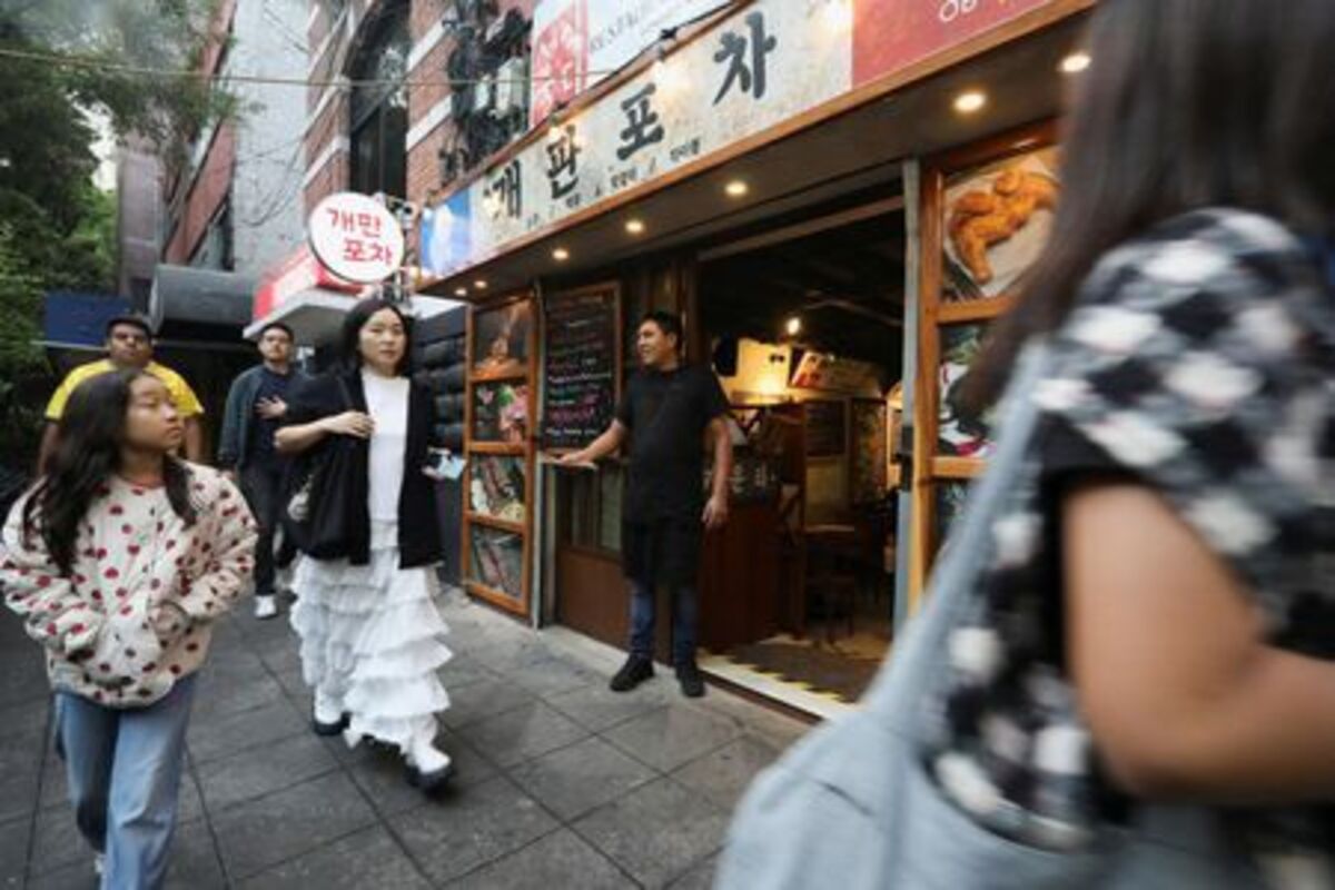 South Koreans walk past Gaepan Pocha restaurant in Little Seoul, as the bond between Korea and Mexico, one of the world’s more unusual geo-cultural connections, continues to grow, with Korean influence gaining a foothold despite distance, language barriers and a 15-hour time difference, in Mexico City, Mexico, June 17, 2026. REUTERS/Paola Garcia