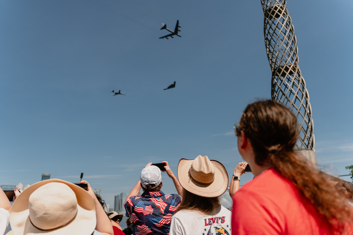 Spectators watch the International Aerial Review from Rockefeller Park in New York, July 4, 2026. America celebrates the 250th anniversary of its independence today, with people from one end of the country to the other marking the milestone with fireworks, parades and concerts. (Lucia Vazquez/The New York Times)