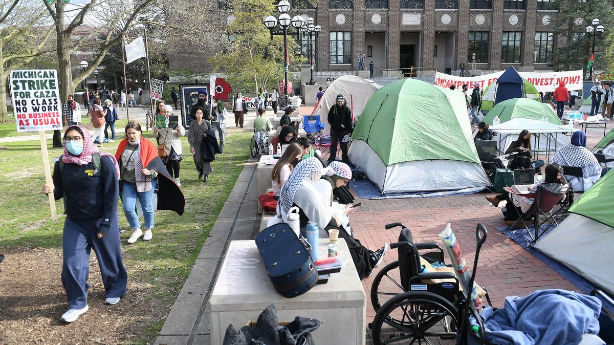 Pro-Palestinian protesters rally to demand the University of Michigan's divestment in Israeli connected companies and weapons manufacturers as they set up an encampment on The Diag at UM on April 22, 2024, in Ann Arbor, Michigan. (Robin Buckson/The Detroit News/TNS)