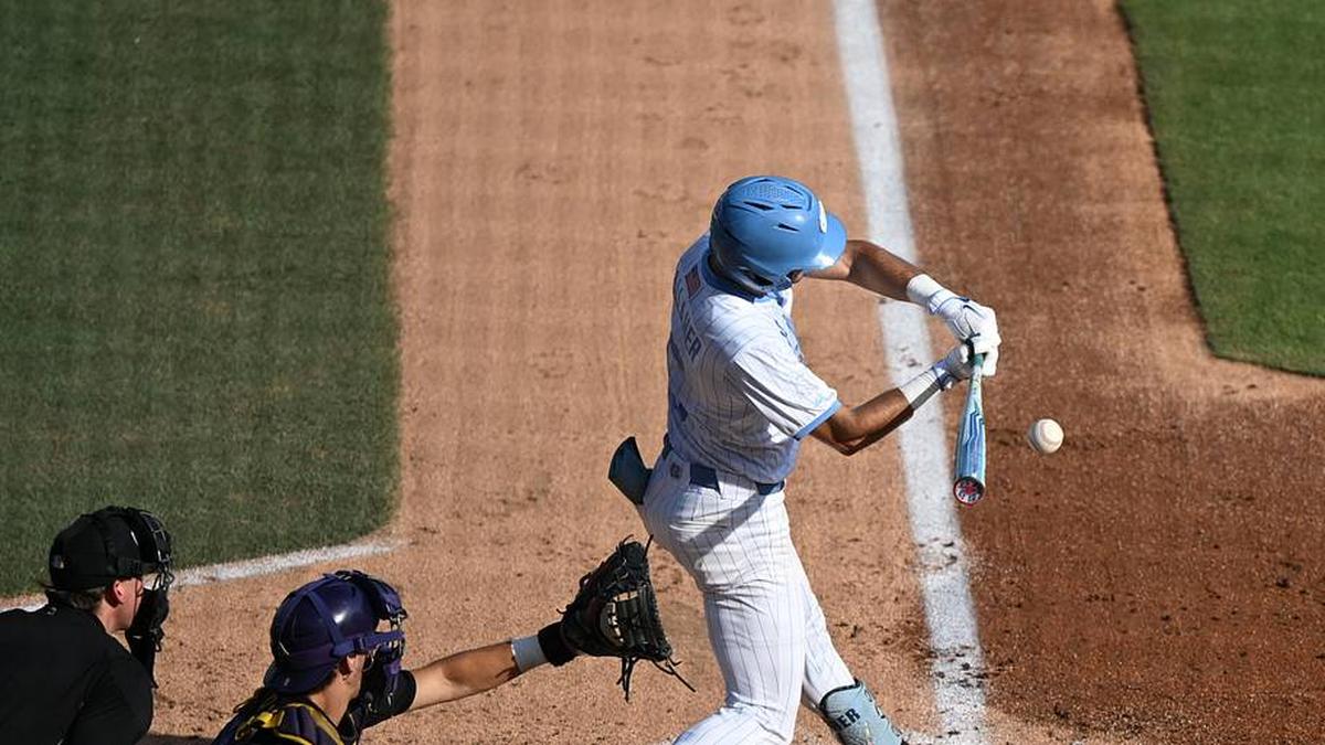  May 31, 2026; Chapel Hill, NC, USA; North Carolina Tar Heels infielder Gavin Gallaher (5) hits the ball against the East Carolina Pirates during game 6 of the Chapel Hill Regional at Boshamer Stadium. | William Howard-Imagn Images 