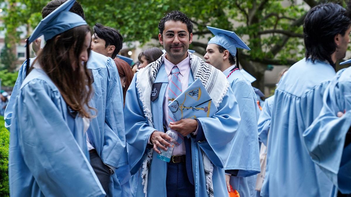 FILE PHOTO: Columbia University student Mohsen Mahdawi stands with other students during the university's commencement ceremony on its main campus, in Manhattan, New York City, U.S., May 21, 2025. REUTERS/Ryan Murphy/ File Photo