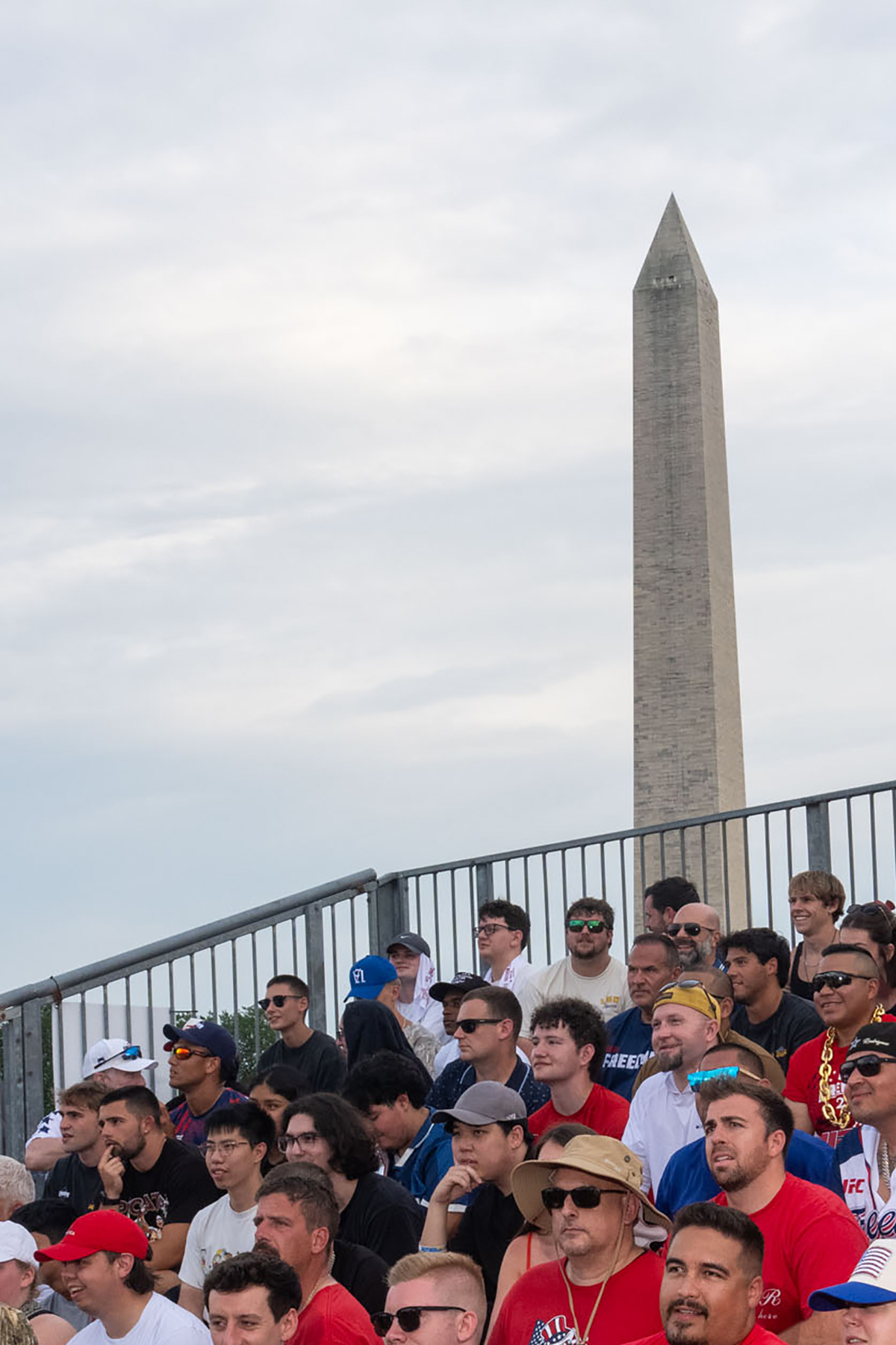 Attendees sit on bleachers ahead of "UFC Freedom 250," a UFC event hosted by President Donald Trump for his 80th birthday, at the Ellipse, a park near the South Lawn of the White House in Washington, on Sunday, June 14, 2026. People from all over the country came to Washington on Sunday for a unique viewing party of the Ultimate Fighting Championship bouts being held on the South Lawn of the White House. (Alex Kent/The New York Times)