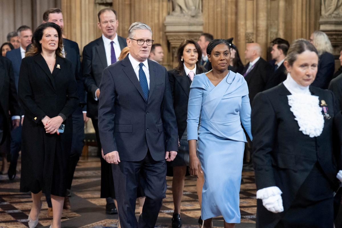 Britain's Prime minister, Keir Starmer and leader of the Conservative Party, Kemi Badenoch return to the House of Commons after listening to the King’s Speech in the House of Lords during the State Opening of Parliament, in London, Britain May 13, 2026.    Stefan Rousseau/Pool via REUTERS