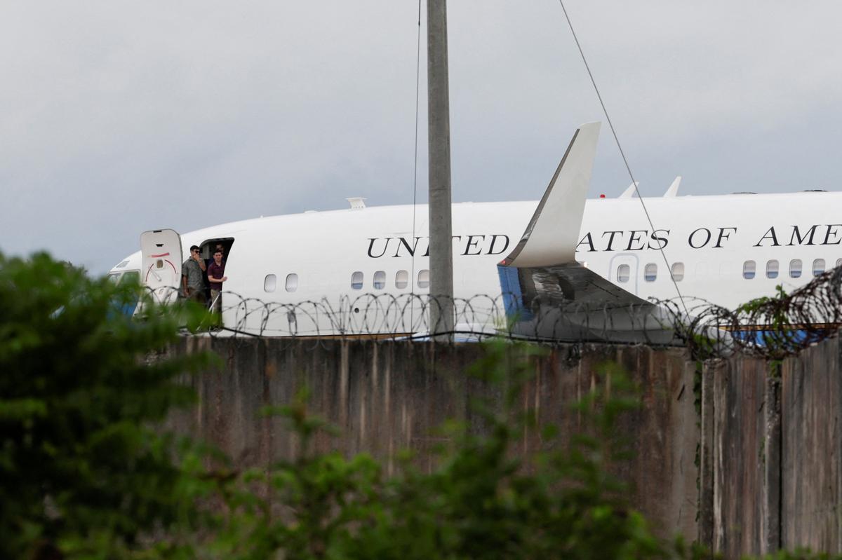 People stand at the gate of a U.S. government plane on the tarmac before departure at Jose Marti International Airport in Havana, Cuba, May 14, 2026. REUTERS/Norlys Perez