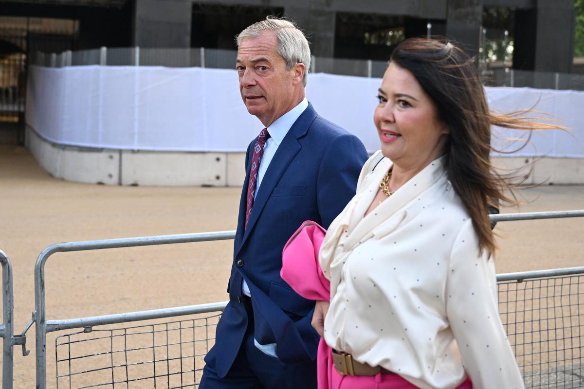 Reform UK Leader Nigel Farage and his partner Laure Ferrari arrive at the Houses of Parliament in London on May 13, 2026, for the State Opening of Parliament.      JUSTIN TALLIS/Pool via REUTERS