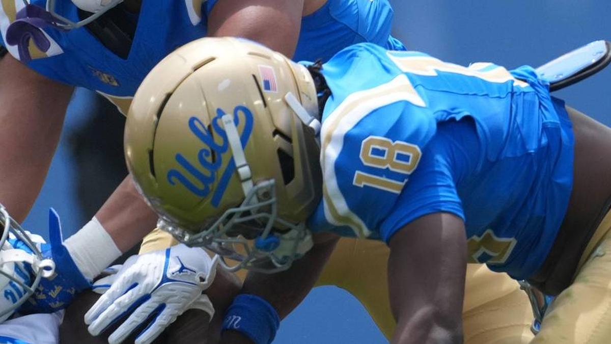  May 2, 2026; Pasadena, CA, USA; UCLA Bruins linebacker Matthew Muasau (57) and defensive backs Osiris Gilbert (18) and Cole Martin (4) tackle receiver Jonah Smith (24) during the spring game at Rose Bowl. Mandatory Credit: Kirby Lee-Imagn Images | Kirby Lee-Imagn Images 
