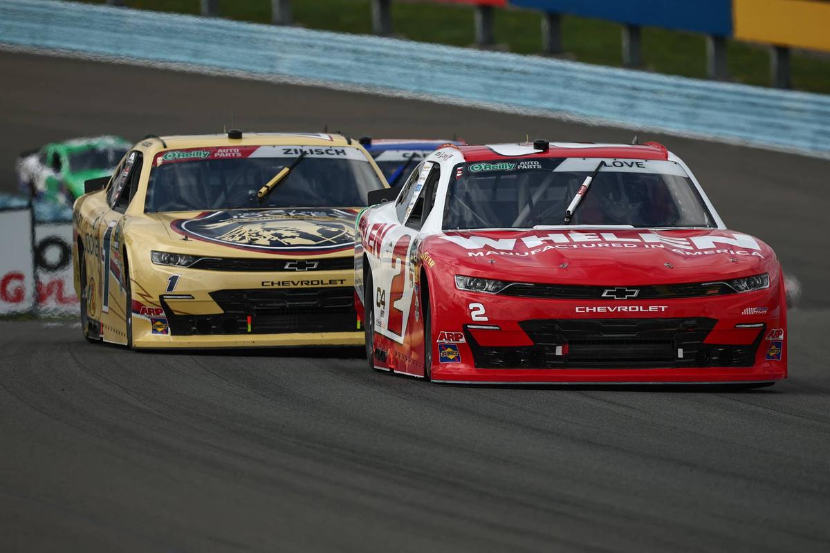  Connor Zilisch peeks from behind Jesse Love while racing at Watkins Glen. (Photo by Chris Graythen/Getty Images)