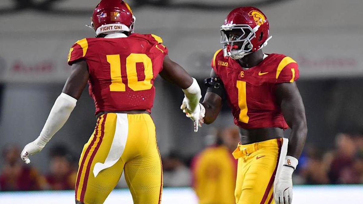  Sep 20, 2025; Los Angeles, California, USA; Southern California Trojans defensive end Braylan Shelby (10) celebrates with defensive end Kameryn Crawford (1) after bringing down Michigan State Spartans quarterback Aidan Chiles (2) during the first half at the Los Angeles Memorial Coliseum. Mandatory Credit: Gary A. Vasquez-Imagn Images | Gary A. Vasquez-Imagn Images 