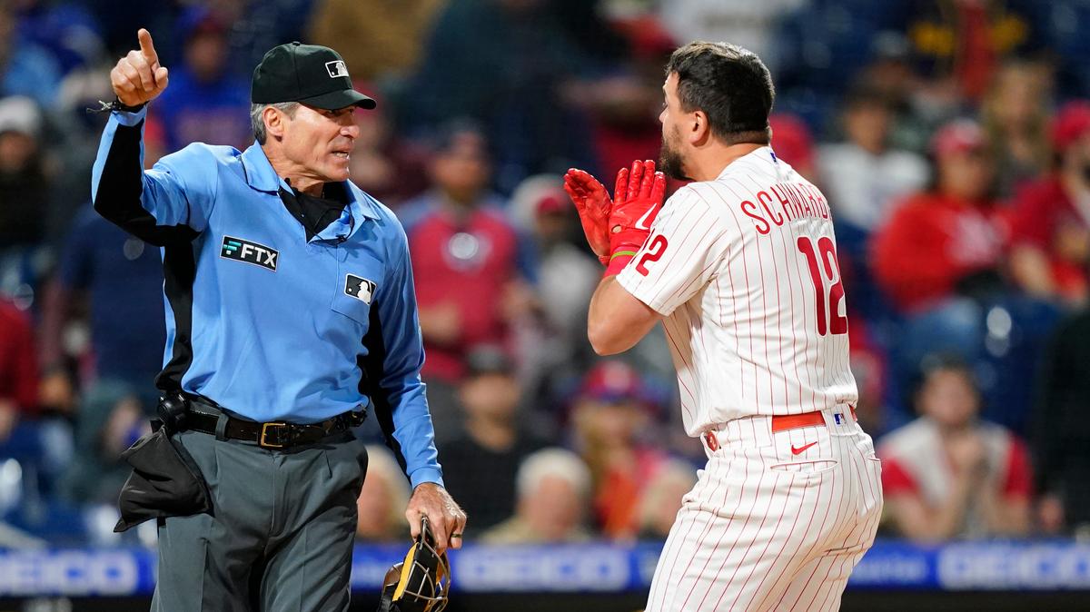 Philadelphia Phillies’ Kyle Schwarber, right, reacts to umpire Angel Hernandez after striking out during the ninth inning of a baseball game against the Milwaukee Brewers, Sunday, April 24, 2022, in Philadelphia. (AP Photo/Matt Slocum)