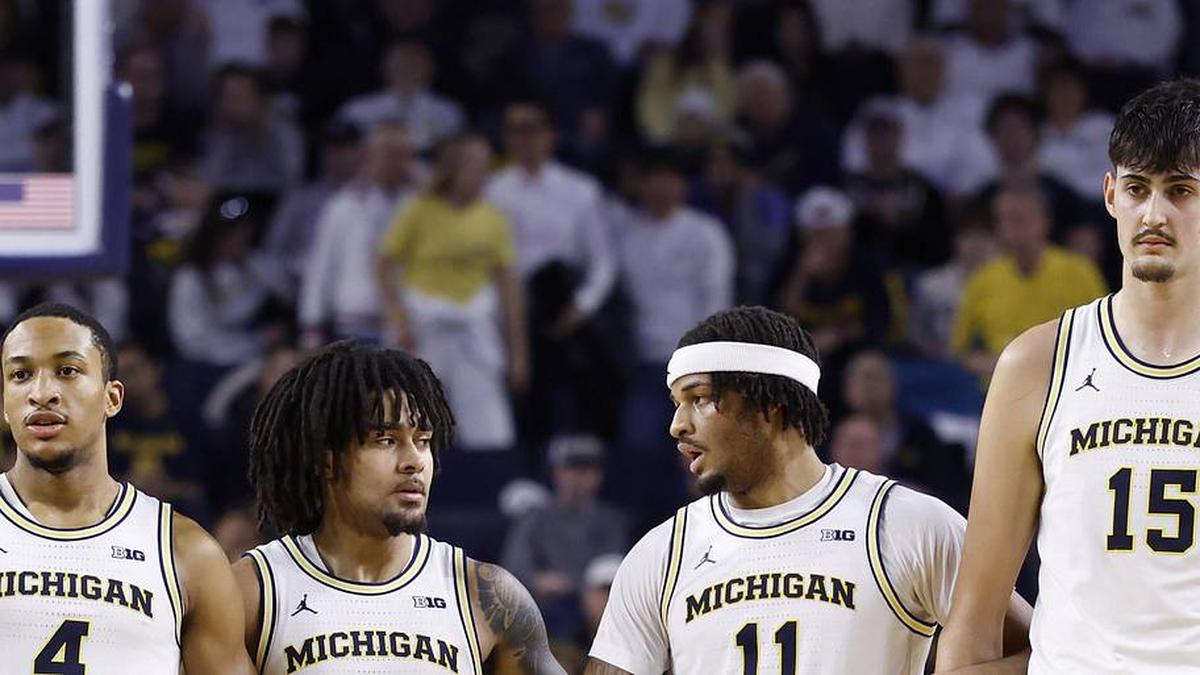  Feb 14, 2026; Ann Arbor, Michigan, USA; Michigan Wolverines guard Nimari Burnett (4) guard Elliot Cadeau (3) guard Roddy Gayle Jr. (11) and center Aday Mara (15) lock arms during the first half against the UCLA Bruins at Crisler Center. Mandatory Credit: Rick Osentoski-Imagn Images | Rick Osentoski-Imagn Images 