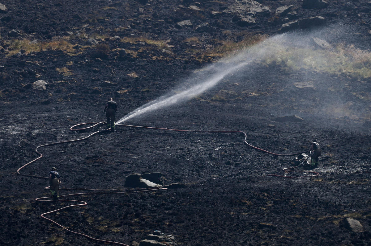 Firefighters fight a moorland blaze near the Dovestone Reservoir in Manchester, Britain, July 13, 2026. REUTERS/Temilade Adelaja