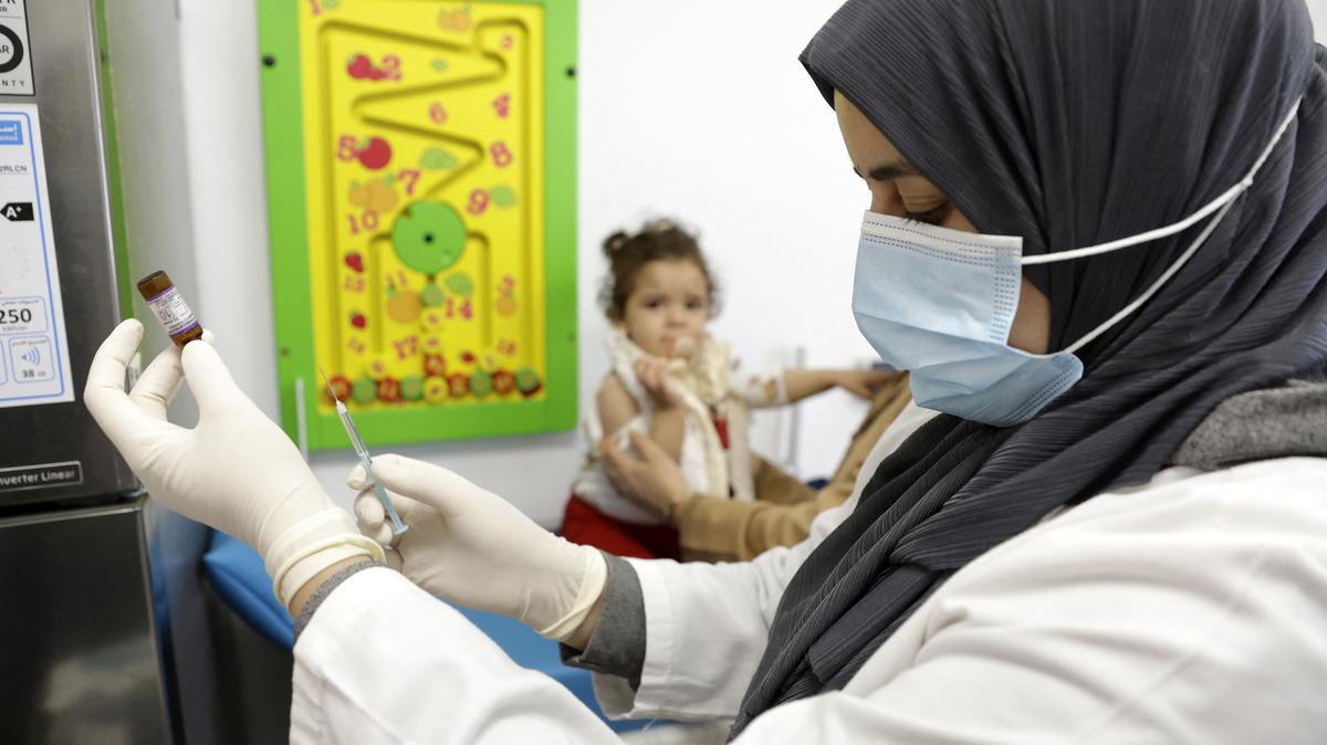 A child waits as a nurse prepares a doze of measles vaccine at a hospital in the Moroccan coastal city of Temara on Feb. 27, 2025. Authorities in Morocco have been scrambling to contain an outbreak of measles, a contagious and potentially fatal disease that had nearly been eradicated in the kingdom but has rebounded as vaccination rates have fallen. (Abdel Majid Bziouat/AFP/Getty Images/TNS)