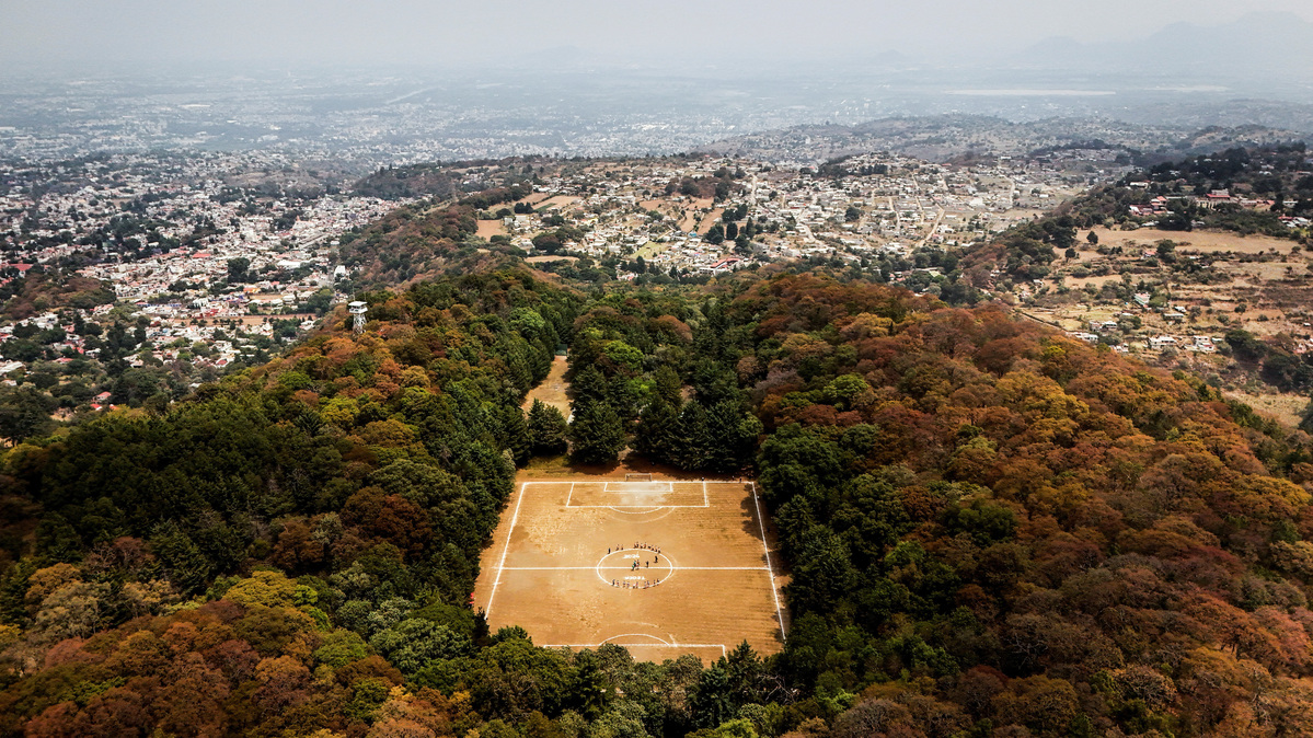 A drone view shows a sports field known as the Field of the Gods, inside the crater of the Teoca volcano, an inactive volcano at more than 2,700 metres above sea level where amateur tournaments are played every Sunday, in Mexico City, Mexico, April 19, 2026. REUTERS/Raquel Cunha