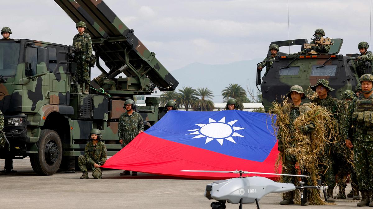 FILE PHOTO: Taiwanese soldiers pose with a Taiwanese flag near a Sky Sword II surface-to-air missile launcher and a military UAV during an annual military exercise ahead of Lunar New Year in Taichung, Taiwan, January 27, 2026. REUTERS/Ann Wang/File Photo