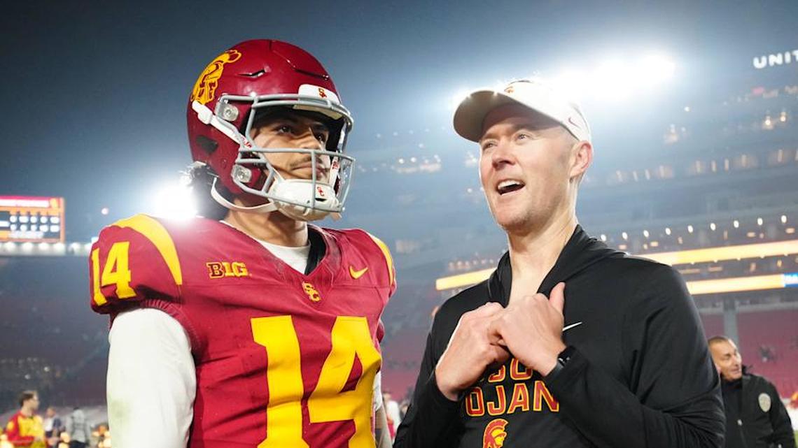  Nov 29, 2025; Los Angeles, California, USA; Southern California Trojans quarterback Jayden Maiava (14) and head coach Lincoln Riley react after the game against the UCLA Bruins at United Airlines Field at Los Angeles Memorial Coliseum. Mandatory Credit: Kirby Lee-Imagn Images | Kirby Lee-Imagn Images 