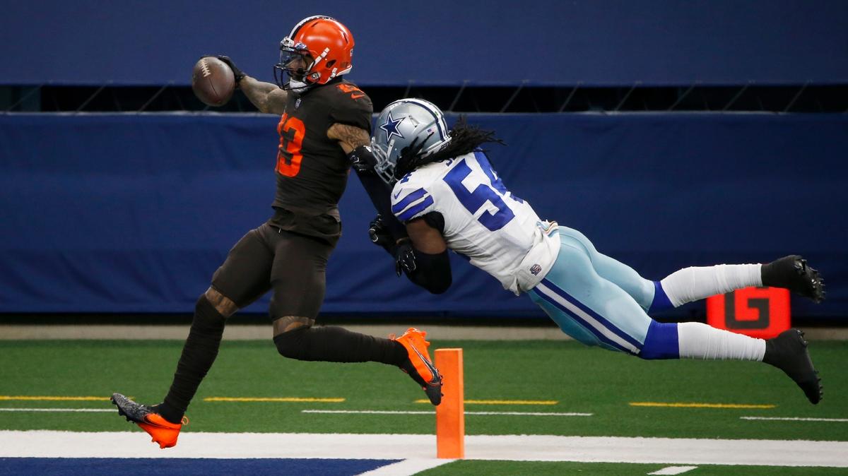 File-This Oct. 4, 2020, file photo shows Cleveland Browns wide receiver Odell Beckham Jr., (13) scoring a touchdown after a long run as Dallas Cowboys linebacker Jaylon Smith (54) attempts the stop in the second half of an NFL football game in Arlington, Texas. Beckham Jr. believes he and his teammates are poised to do something big this season. Appearing at his youth football camp, Beckham, who has made a speedy recovery from a season-ending knee injury in 2020, said there’s a vibe about the Browns. (AP Photo/Michael Ainsworth, File)
