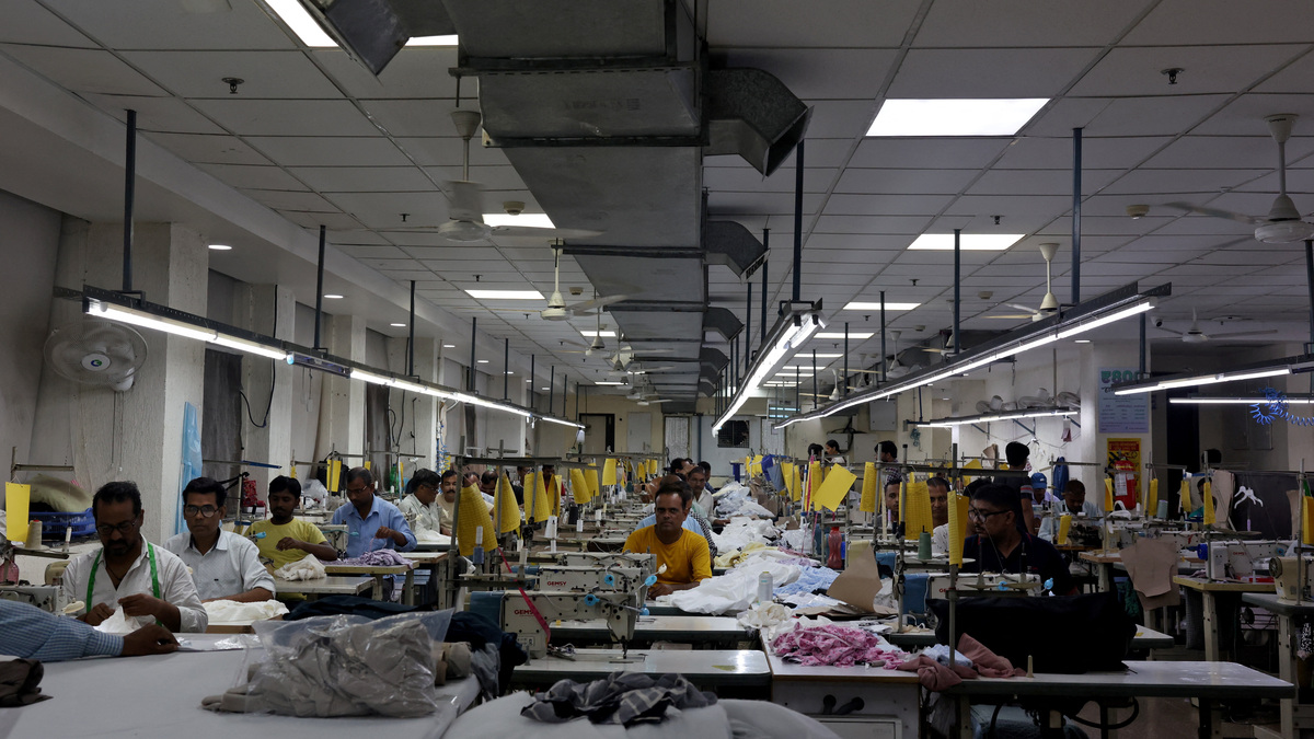 Garment workers stitch clothes at a textile factory in Noida, India, July 31, 2025. REUTERS/ Bhawika Chhabra