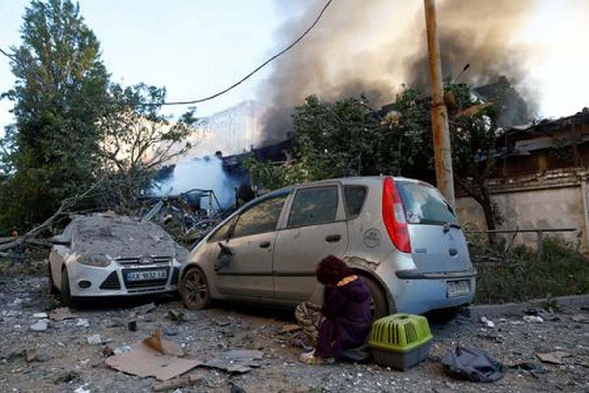 A child sits at the site of Russian missile and drone strikes, amid Russia's attack on Ukraine, in Kyiv, Ukraine June 2, 2026. REUTERS/Valentyn Ogirenko