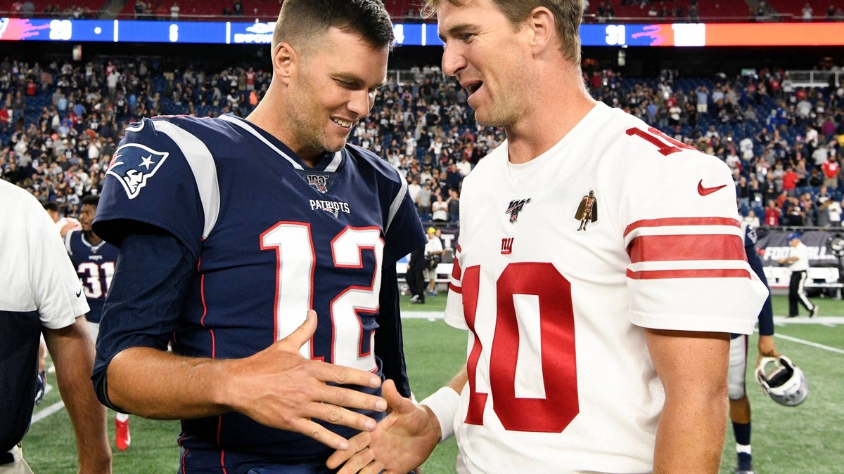 New England Patriots quarterback Tom Brady and New York Giants quarterback Eli Manning shake hands after a preseason game at Gillette Stadium.