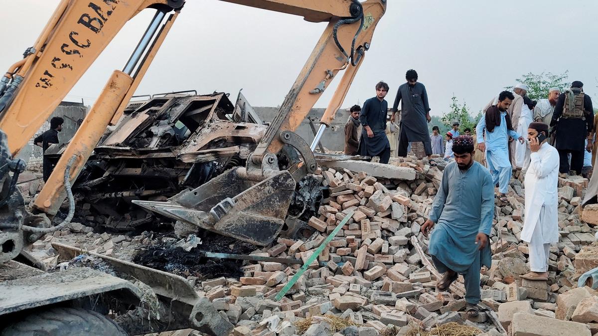 Residents gather on the rubble of a damaged police post after a car bombing in Bannu, Khyber Pakhtunkhwa province, Pakistan May 10, 2026. Picture taken with a mobile phone. REUTERS/Ehsan Khattak