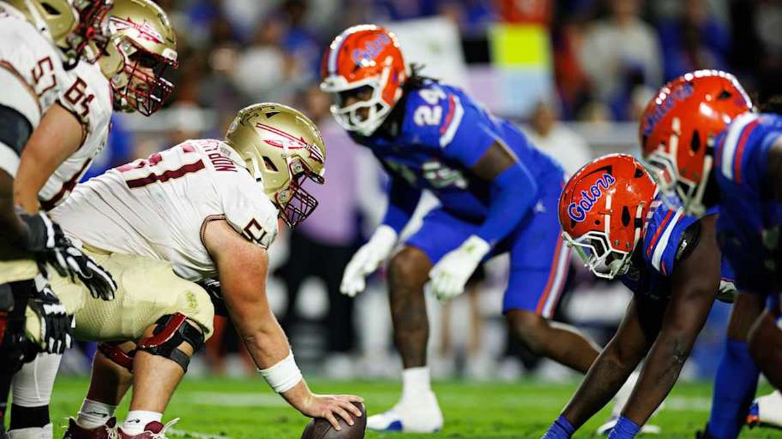  Nov 29, 2025; Gainesville, Florida, USA; Florida State Seminoles offensive lineman Luke Petitbon (51) waits to the snap the ball while Florida Gators linebacker Jake Xeller (50) defends during the second half at Ben Hill Griffin Stadium. Mandatory Credit: Matt Pendleton-Imagn Images | Matt Pendleton-Imagn Images 
