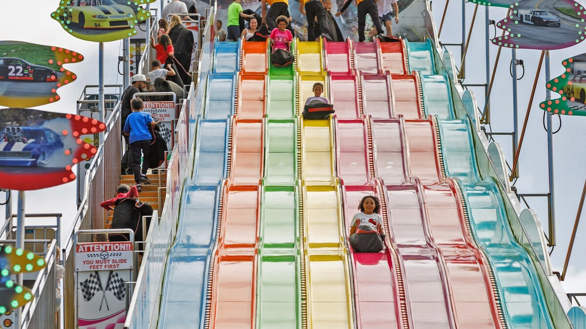 Children go down a giant slide on opening day of the San Diego County Fair in Del Mar on Wednesday, June 10, 2026. (Kristian Carreon / The San Diego Union-Tribune)