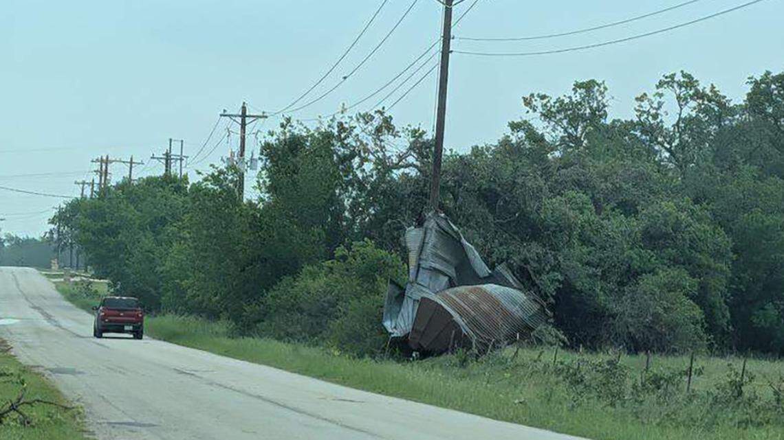 Scrap metal is wrapped around a power pole in Springtown, Texas, on Sunday, a day after a severe storm swept through the area. Two people were killed and 20 families were displaced, authorities said.