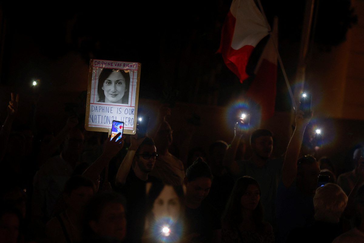 A photo of journalist Daphne Caruana Galizia is illuminated by the flashes of mobile phones after a protest march on the sixth anniversary of her assassination, in Valletta, Malta October 16, 2023. REUTERS/Darrin Zammit Lupi