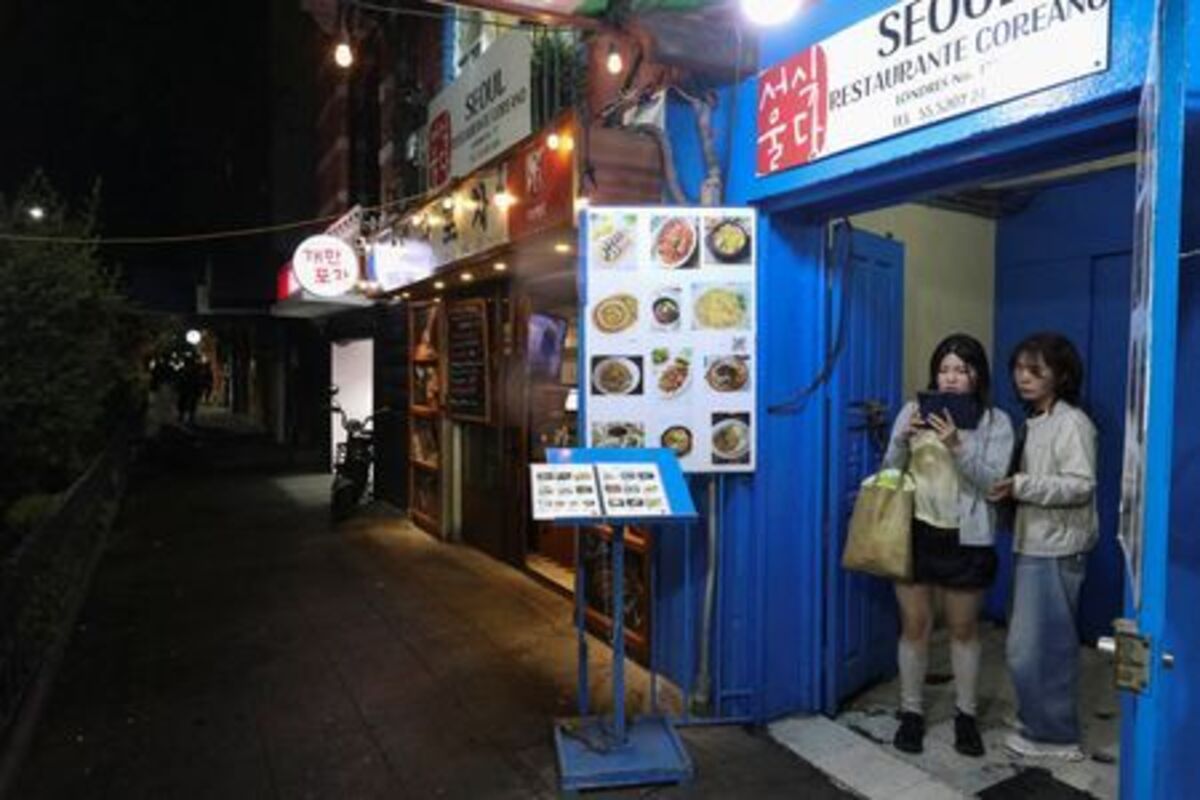 South Koreans stand at the entrance of Seoul restaurant in Little Seoul, as the bond between Korea and Mexico is one of the world’s more unusual geo‑cultural love stories, with Korean influence gaining a foothold despite distance, language and a 15-hour time difference, in Mexico City, Mexico June 17, 2026. REUTERS/Paola Garcia