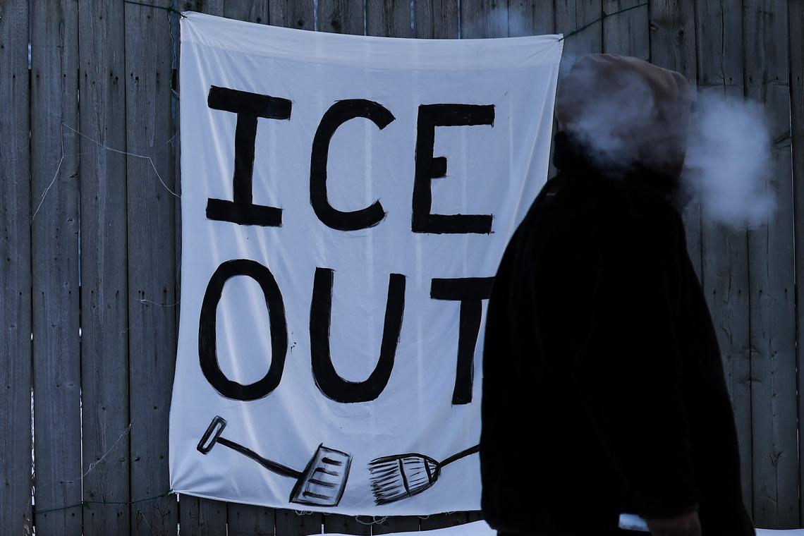  A man walks past an anti-ICE sign hanging on a fence in Minneapolis, Minnesota, on February 3, 2026. 