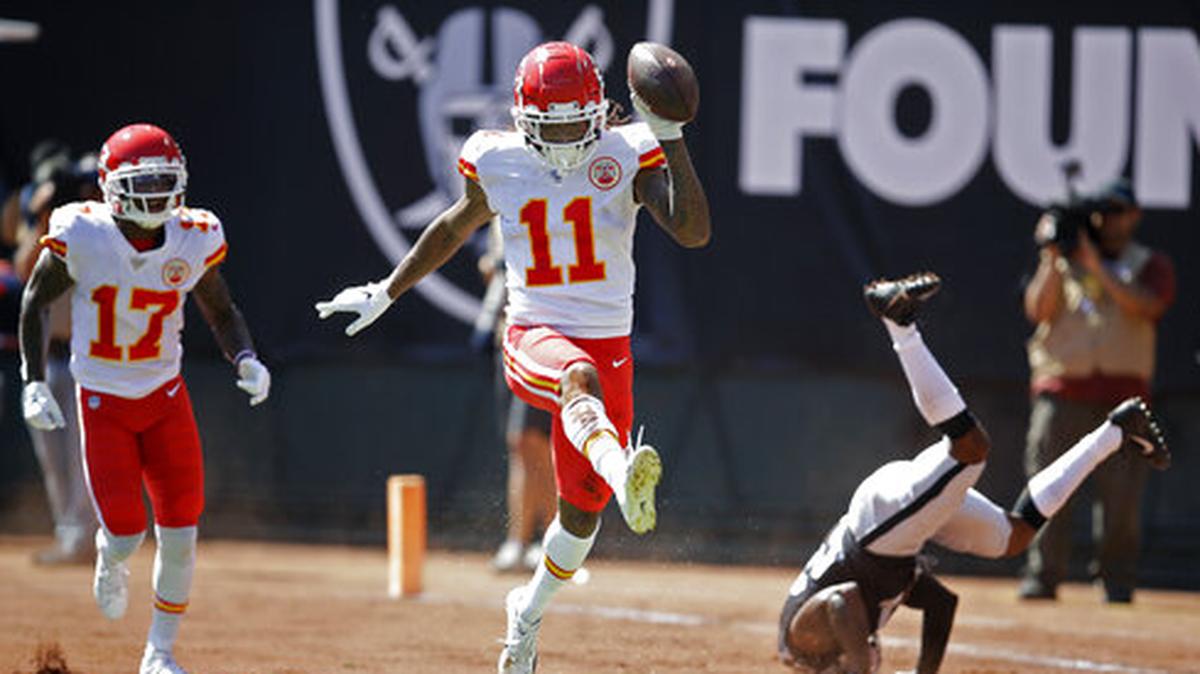 Kansas City Chiefs wide receiver Demarcus Robinson (11) celebrates after scoring a touchdown as teammate Mecole Hardman (17) looks on during the first half of an NFL football game against the Oakland Raiders Sunday, Sept. 15, 2019, in Oakland, Calif. At right is Oakland Raiders cornerback Gareon Conley.
