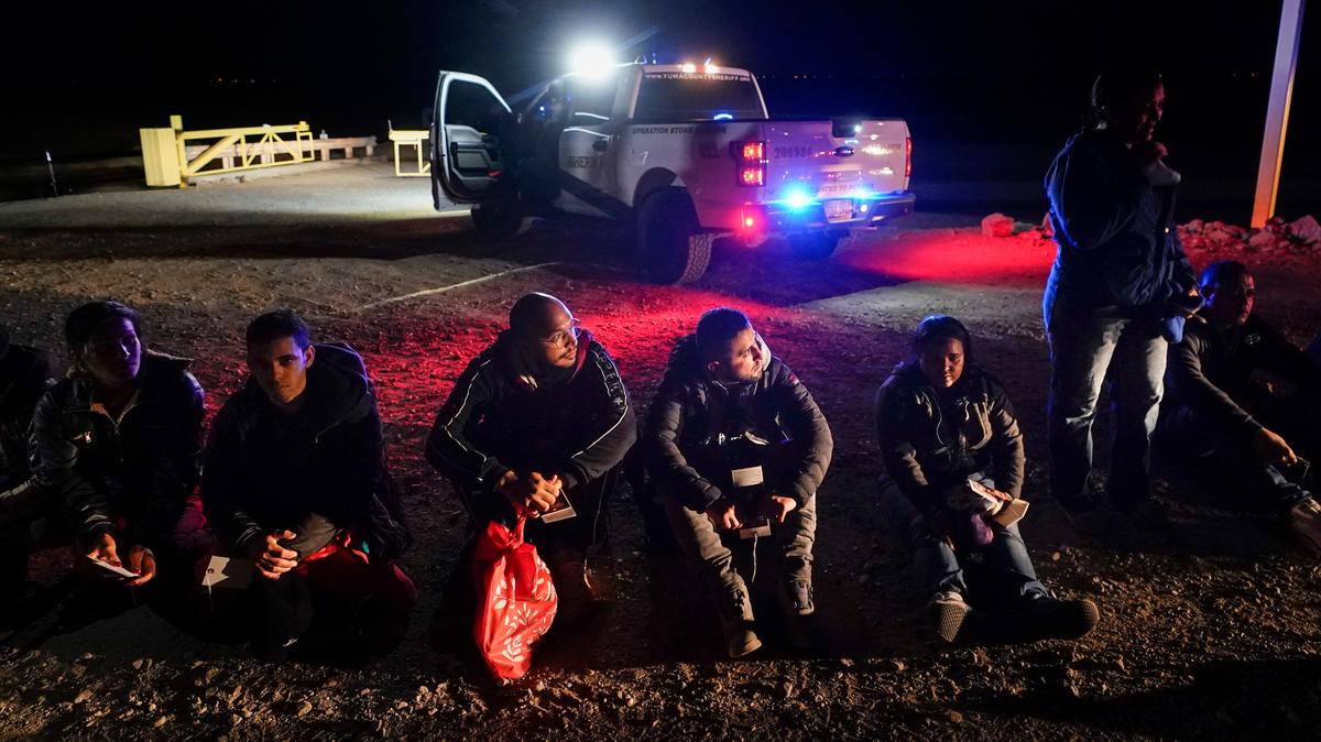 Varios inmigrantes esperan ser procesados ​​después de cruzar la frontera con México, el 6 de enero de 2023, cerca de Yuma, Arizona. (Foto AP/Gregory Bull, File)