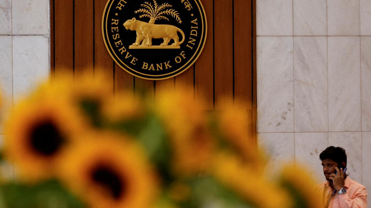 File Photo: A man speaks on his phone as he walks past the Reserve Bank of India (RBI) logo inside its headquarters in Mumbai, India, February 7, 2025. REUTERS/Francis Mascarenhas/File Photo